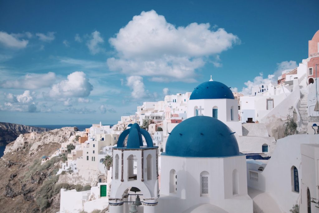 reach the greek islands by direct flight from london to see blue domed white buildings.